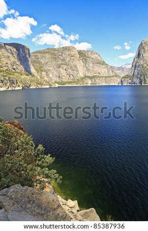 Hetch Hetchy rises above the reservoir on a Spring day at Hetch Hetchy Reservoir in Yosemite National Park, California