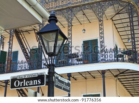 A lamp post and wrought iron balconies at the corner of Orleans and Dauphine streets in the French Quarter of New Orleans