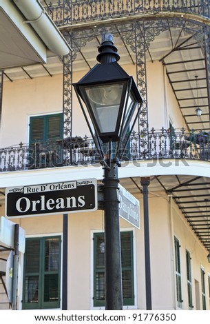A lamp post and wrought iron balconies at the corner of Orleans and Dauphine streets in the French Quarter of New Orleans, Louisiana