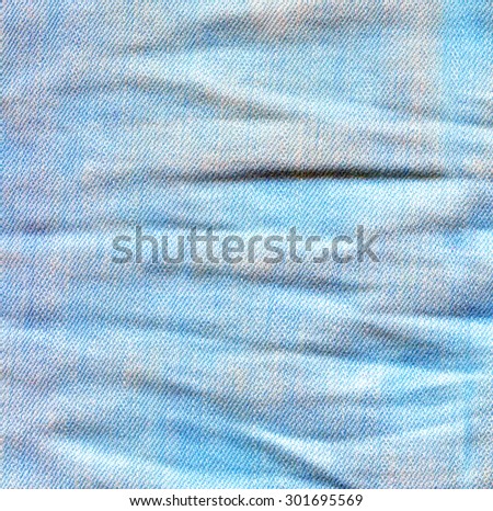 Crumpled jeans background. Battered denim surface. Light blue gray white color canvas texture