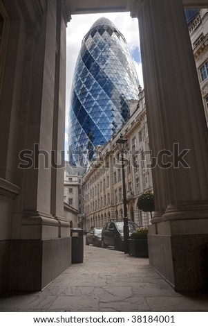 The famous London Gherkin tower framed between columns