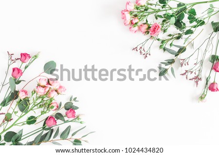 Flowers composition. Frame made of various pink flowers and eucalyptus branches on white background. Flat lay, top view, copy space