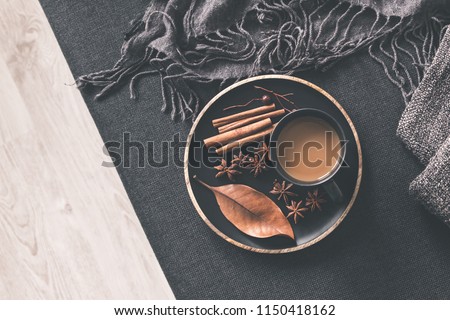 Autumn home decor. Cup of coffee, cinnamon sticks, anise stars on wooden tray. Autumn, fall concept. Flat lay, top view