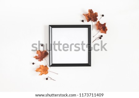 Autumn composition. Photo frame, dried leaves on white background. Autumn, fall, halloween concept. Flat lay, top view, copy space, square