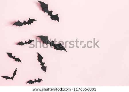 Halloween paper decorations on pastel pink background. Halloween concept. Flat lay, top view, copy space