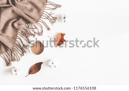 Autumn composition. Cup of coffee, plaid, dried leaves on white background. Autumn, fall concept. Flat lay, top view, copy space