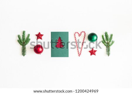 Christmas composition. Postcard, fir tree branches, red and green decorations on white background. Christmas, winter, new year concept. Flat lay, top view