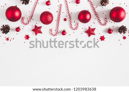 Christmas composition. Border made of red decorations on white background. Christmas, winter, new year concept. Flat lay, top view, copy space