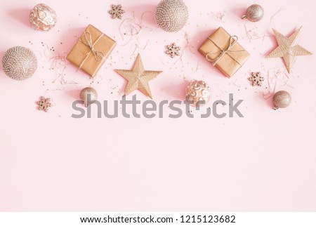 Christmas composition. Christmas gifts, golden decorations on pastel pink background. Flat lay, top view, copy space