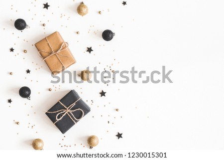 Christmas composition. Gifts, black and golden decorations on white background. Christmas, winter, new year concept. Flat lay, top view, copy space