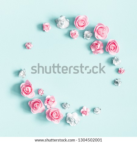 Flowers composition. Wreath made of rose flowers on pastel blue background. Valentines day, mothers day, womens day, spring concept. Flat lay, top view, copy space, square