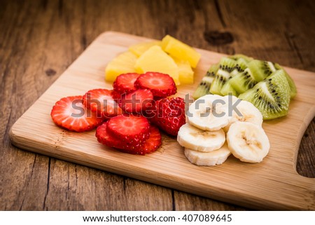 Sliced fruit on a cutting board. Ingredients for fruit salad