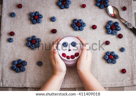 Healthy breakfast of yogurt and berries. Child creative breakfast. Top view