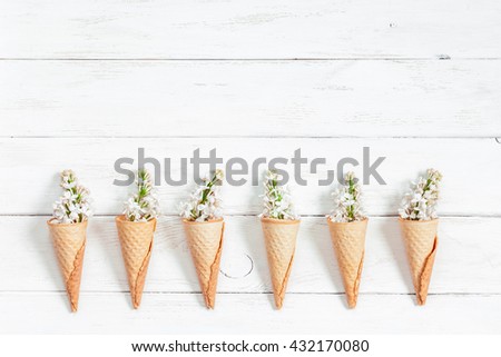 Lilac flowers in ice cream cone. Pattern. Creative flowers. Flat lay, top view