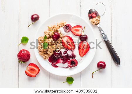 Porridge. Healthy breakfast with yogurt, muesli and berries. Top view, flat lay