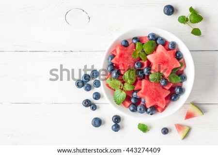 Summer fruit salad of watermelon and blueberries. Slices of watermelon in the shape of a star. Top view, flat lay