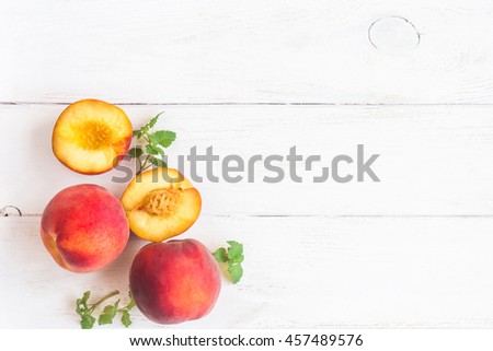 Fresh peaches on wooden white background. Summer peaches top view, flat lay