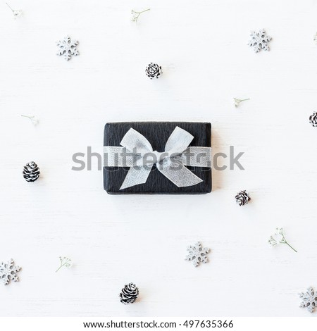 Christmas composition. Christmas gift, snowflakes, pine cones and gypsophila flowers. Top view, flat lay