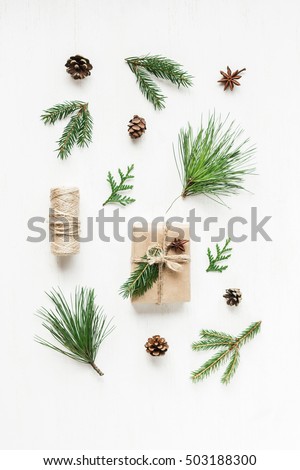Christmas composition with pine cones, fir branches, christmas gift. Top view, flat lay