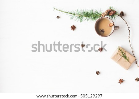 Christmas composition. Cup of coffee, larch branches, cinnamon sticks, anise star. Christmas background. Flat lay, top view