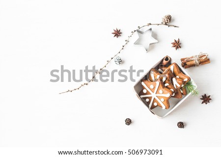 Christmas composition. Gift, larch branches, cinnamon sticks, anise star, christmas cookies. Flat lay, top view