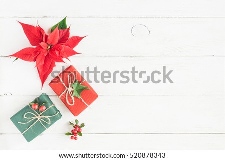 Christmas composition. Gifts, fir branches, christmas poinsettia. Flat lay, top view