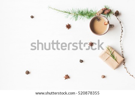 Christmas composition. Cup of coffee, larch branches, cinnamon sticks, anise star. Christmas background. Flat lay, top view