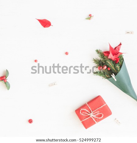 Christmas composition. Gift, bouquet made of traditional christmas plants. Flat lay, top view.