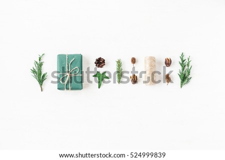 Christmas composition with pine cones, cypress branches, christmas gift. Top view, flat lay.