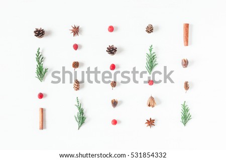 Christmas pattern of pine cones, cypress branches, cranberry, cinnamon sticks. Top view, flat lay
