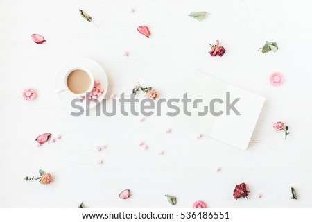 Flowers composition. Cup of coffee, notepad, dried flowers and leaves. Top view, flat lay
