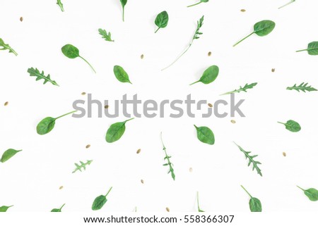 Frame made of arugula, spinach leaves on white background. Flat lay, top view