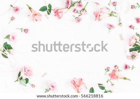 Flowers composition. Frame made of pink flowers and leaves. Top view, flat lay