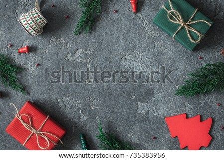 Christmas composition. Frame made of christmas gifts, pine branches, toys on black background. Flat lay, top view, copy space