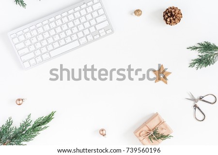 Christmas home office desk with computer, pine branches, christmas gift, golden decorations. Flat lay, top view, copy space
