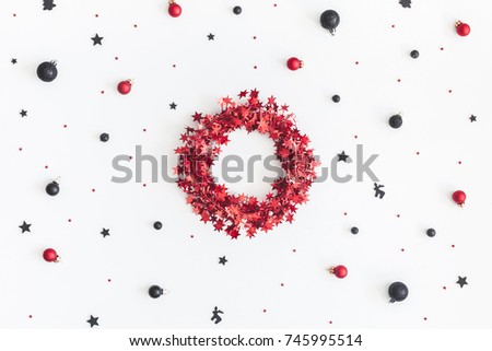 Christmas composition. Christmas wreath, black and red decorations on white background. Flat lay, top view, copy space
