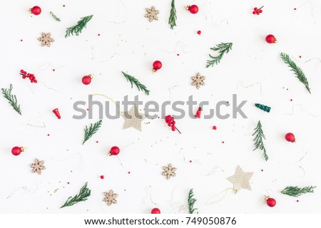 Christmas composition. Pattern made of christmas tree branches, golden decorations and red berries on white background. Flat lay, top view