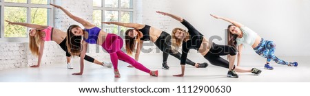 Young women carry out training in dance class. Banner for website.  The concept of sport, dance and a healthy lifestyle.