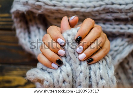 Luxury short manicure  on a dark wooden background. cozy autumn nails