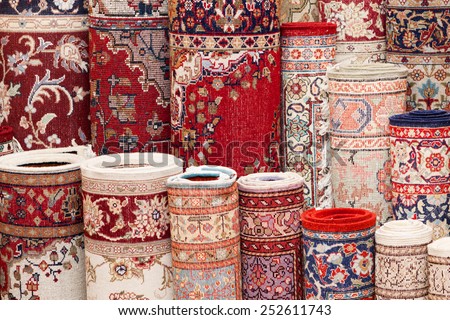Close up of various handmade Persian carpets in a shop