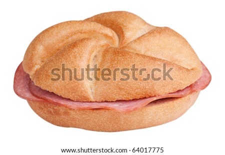 Bread roll with sausage in front of white background and clipping path
