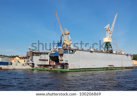 Hoisting cranes at shipyards in the blue sky