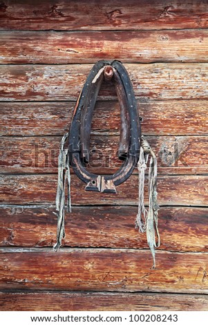 The old horse clamp in the log wooden wall