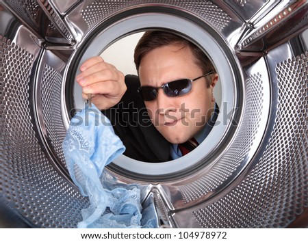 Detective searches through the dirty clothes in the washing machine