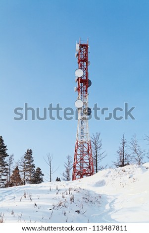 Tower with antennas of cellular communication on the background of blue sky