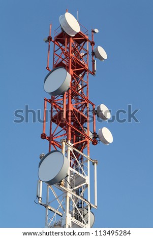 Tower with antennas of cellular communication on the background of blue sky