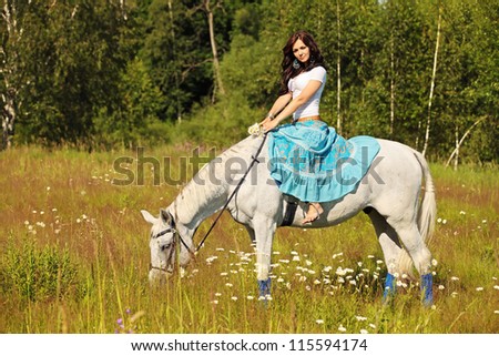 Young peasant woman rides a horse