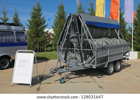 NIZHNY TAGIL, RUSSIA - AUG 23: The police trailer with barbed wire for the installation of fences at the exhibition RUSSIAN DEFENCE EXPO 2012 on August, 23, 2012 in Nizhny Tagil, Russia
