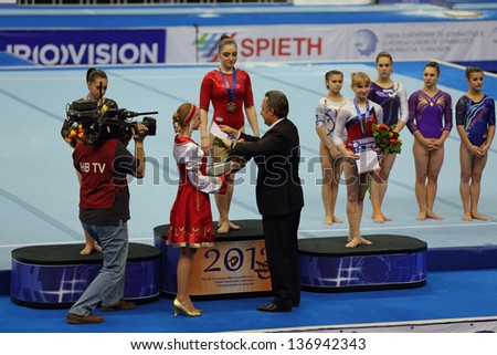MOSCOW - APR 19: 2013 European Artistic Gymnastics Championships. Winners All-Around - Aliya Mustafina, Larisa Iordache and Anastasia Grishina in Olympic Stadium on April 19, 2013 in Moscow, Russia