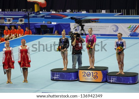 MOSCOW - APR 20: 2013 European Artistic Gymnastics Championships. Awarding of winners Uneven Bars - Aliya Mustafina, Jonna Adlerteg, Maria Paseka in Olympic Stadium on April 20, 2013 in Moscow, Russia